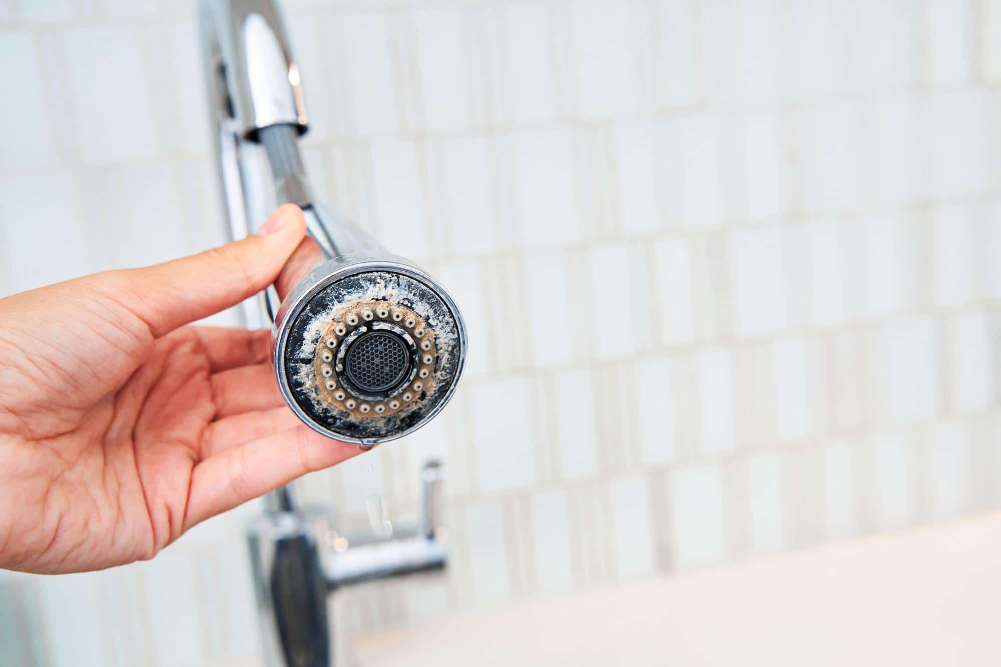 chrome faucet covered in limescale