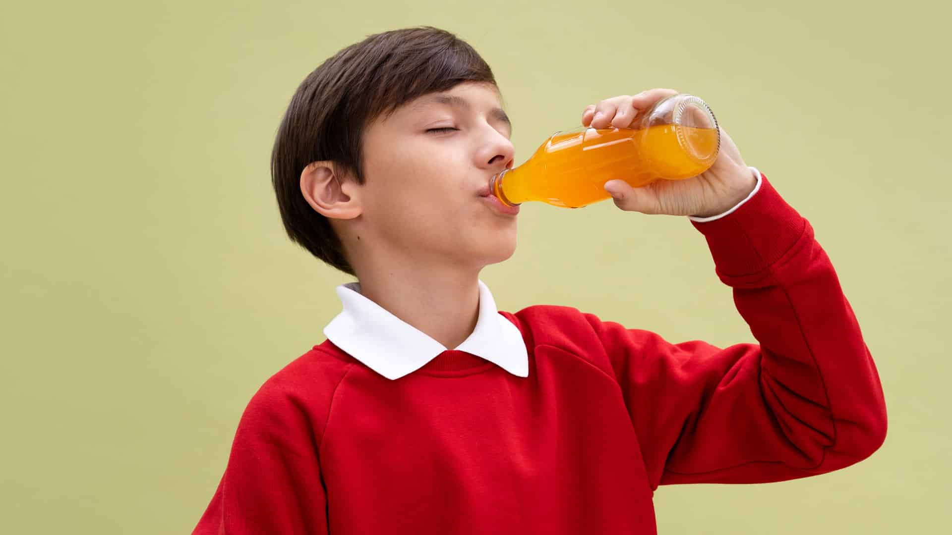 young boy drinking soft drink